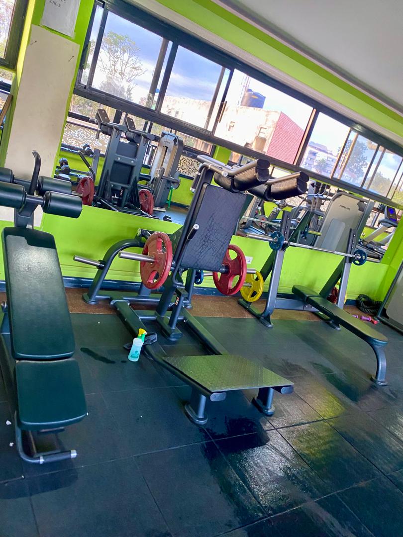 Plate-loaded squat machine and benches at Shiloh Gym